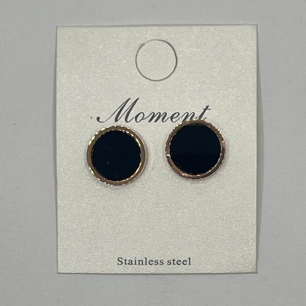 Black earrings with STAINLESS STEEL rims on a 'Moment' branded card.
