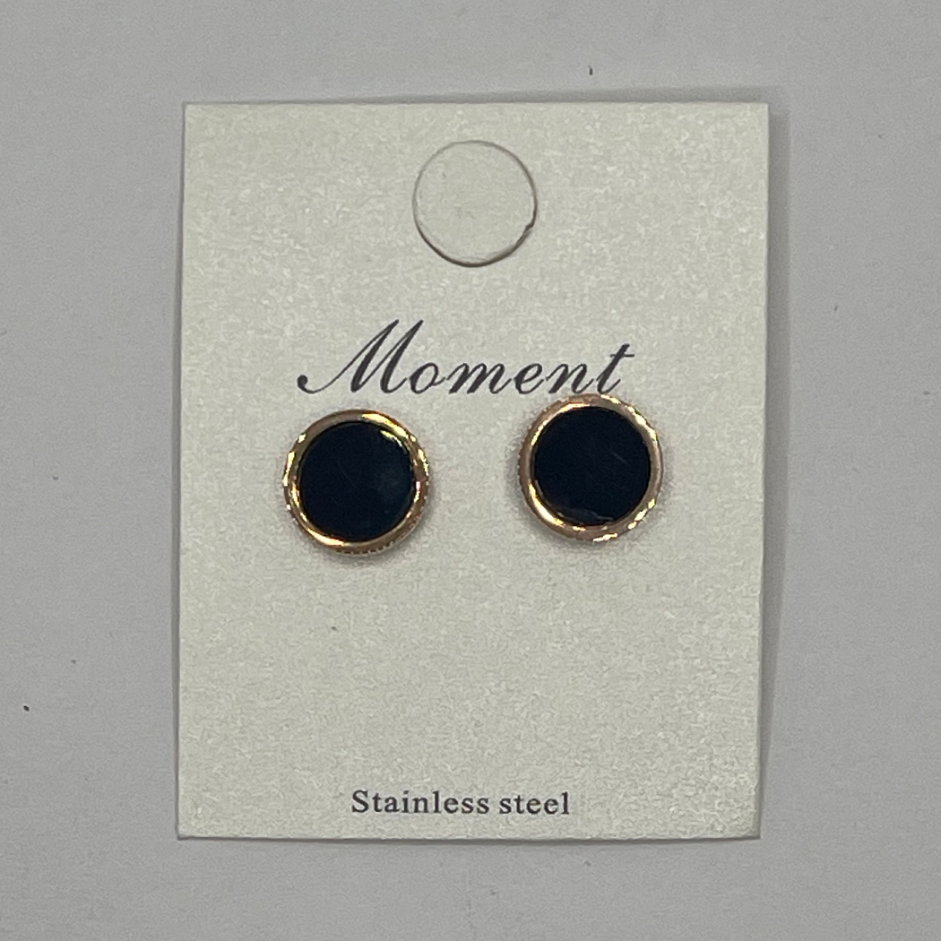 Pair of black round earrings with STAINLESS STEELrims on a 'Moment' branded card.