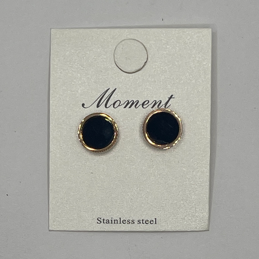 Pair of black round earrings with STAINLESS STEELrims on a 'Moment' branded card.